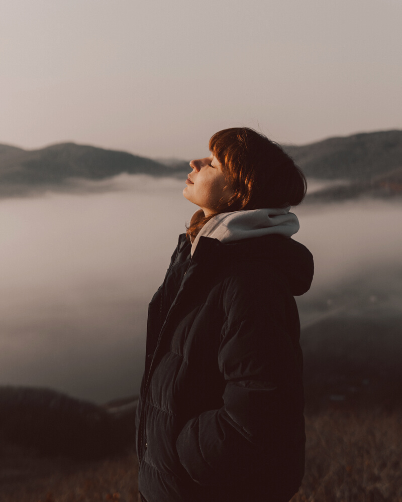 Woman Enjoying Fresh Air in Mountains 